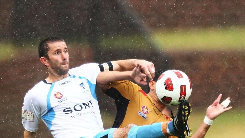 Terry McFlynn battles in the tough conditions as Sydney's season slips away.