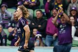 Ryan Papenhuyzen runs onto the field for an NRL game as Melbourne Storm fans cheer behind him.