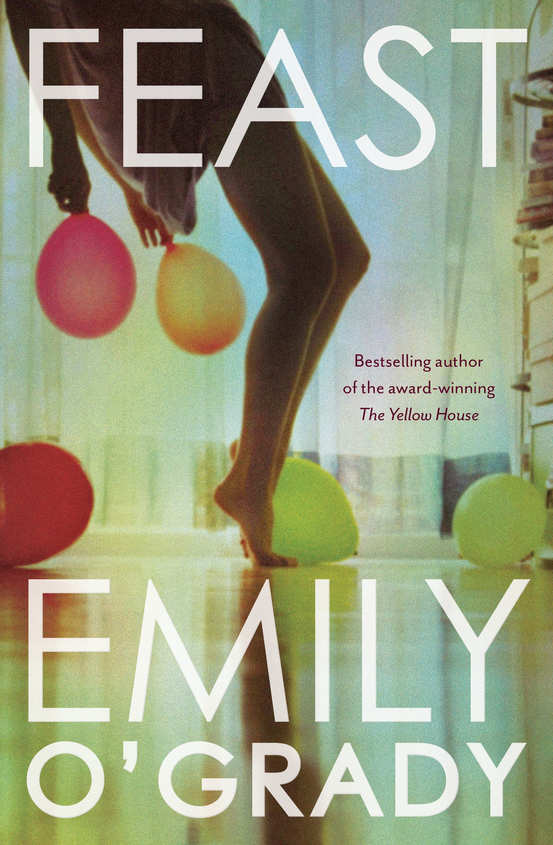 A book cover showing a photograph of a young woman's bare legs and balloons scattered about