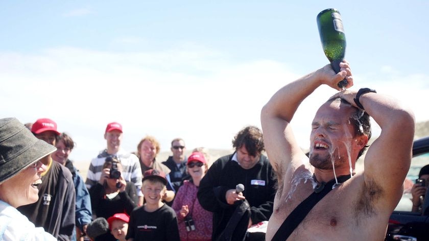 Trans-Tasman rower Shaun Quincey celebrates his arrival at Ninety Mile Beach