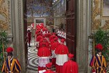Cardinals enter the door of the Sistine Chapel