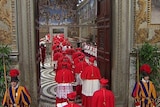 Cardinals enter the door of the Sistine Chapel