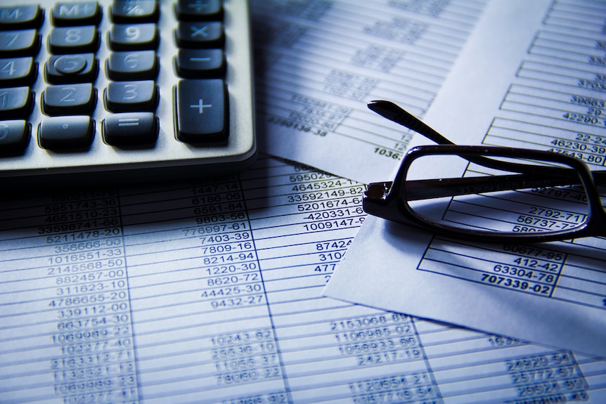 Glasses and a calculator on accounting documents