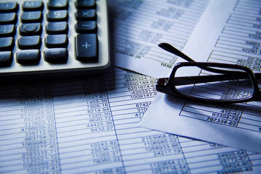 Glasses and a calculator on accounting documents