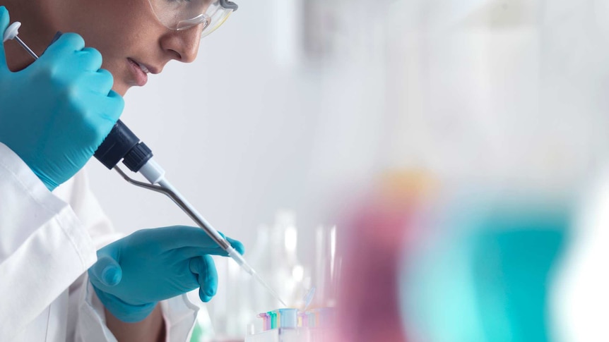 Scientist pipetting samples into micro centrifuge tubes ready