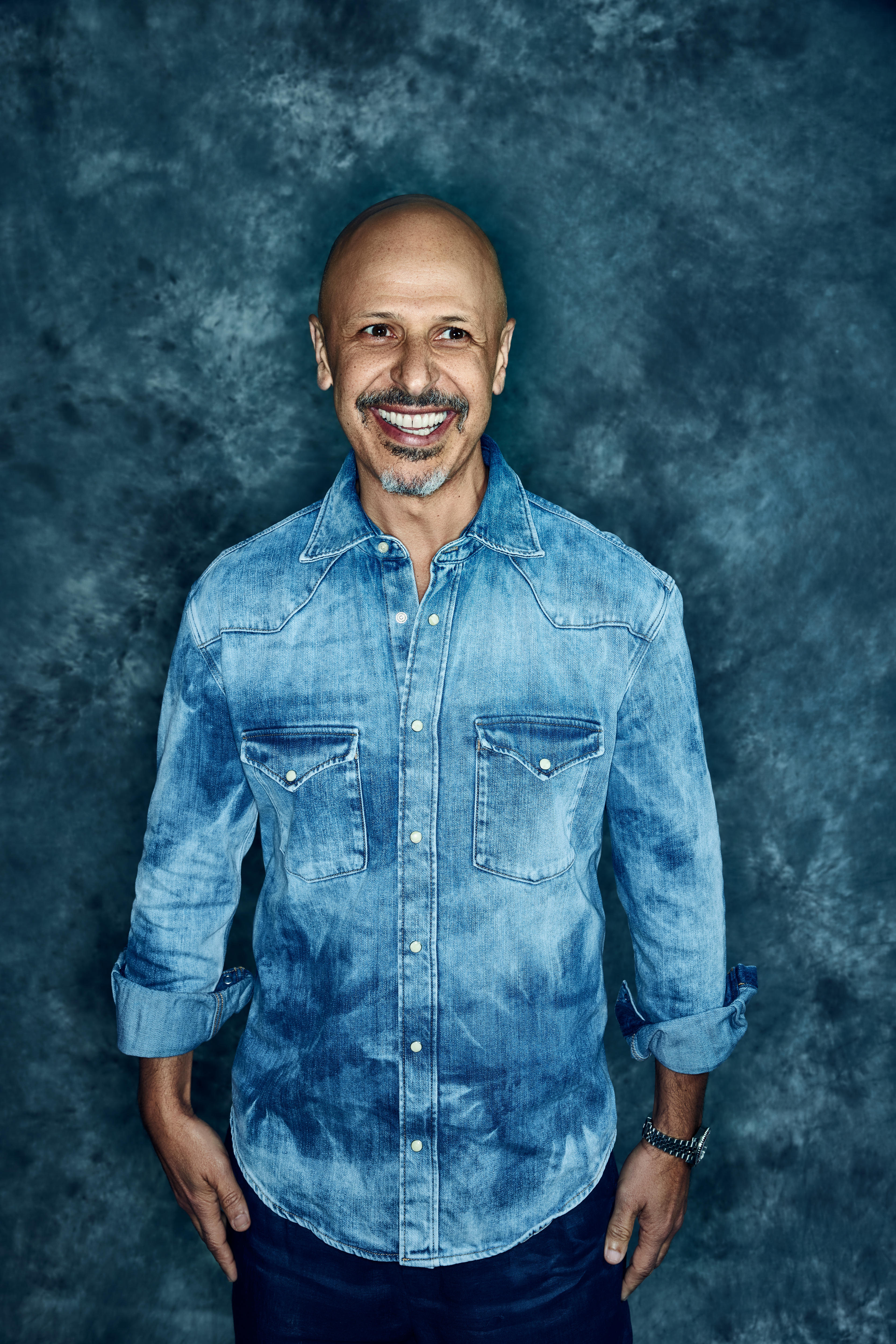 Man wearing light denim smiling 