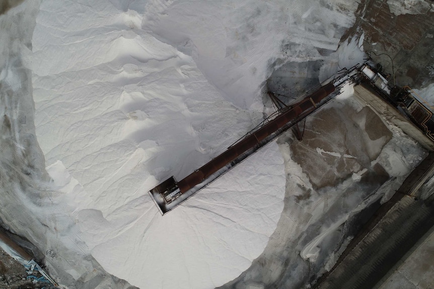 A big white pile of salt and an auger