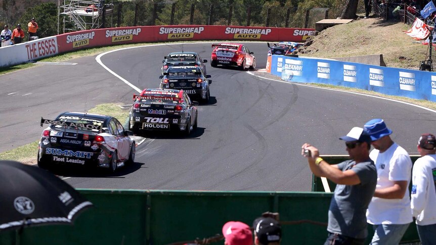 Fans watch the V8 super cars race over the top of Mount Panorama.