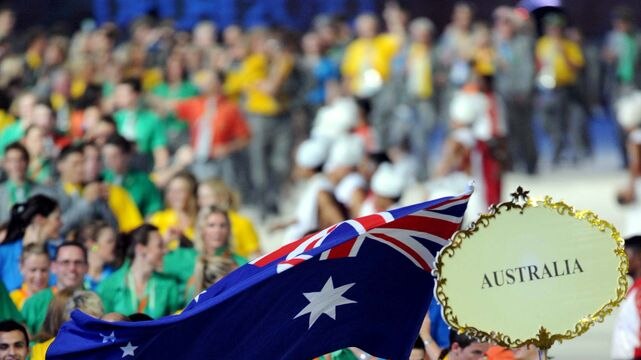 Flag-bearer Sharelle McMahon leads the Australian team
