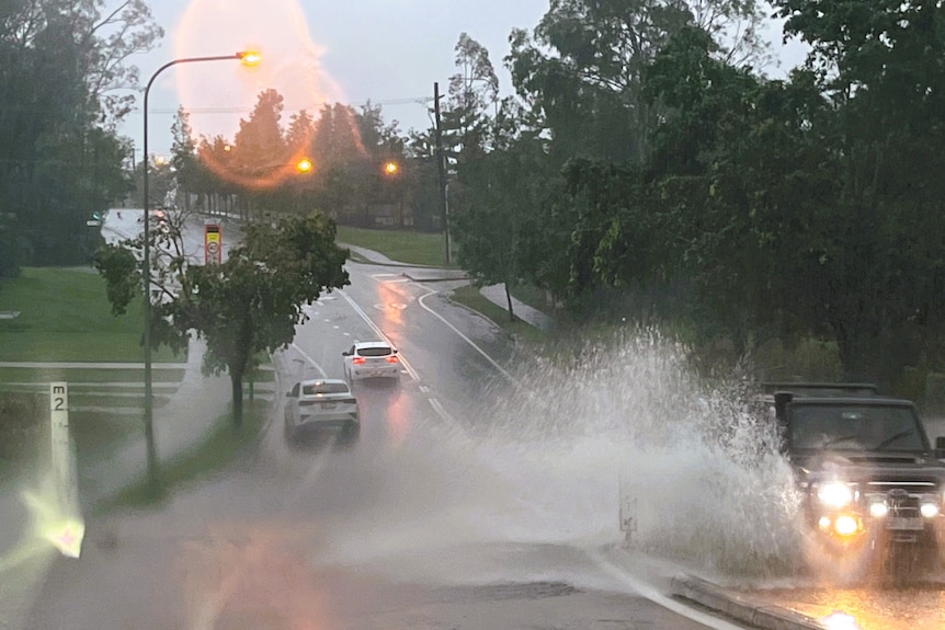 Car driving through floodwaters in south-east Queensland.