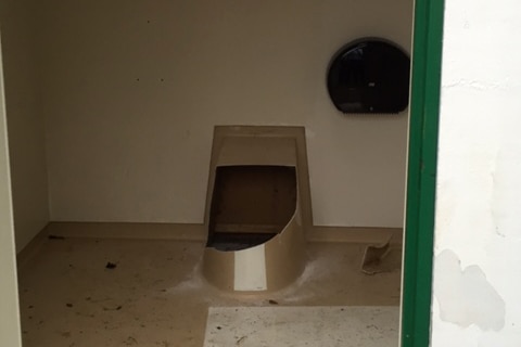 A toilet cut open inside an outhouse in Drammen, Norway.