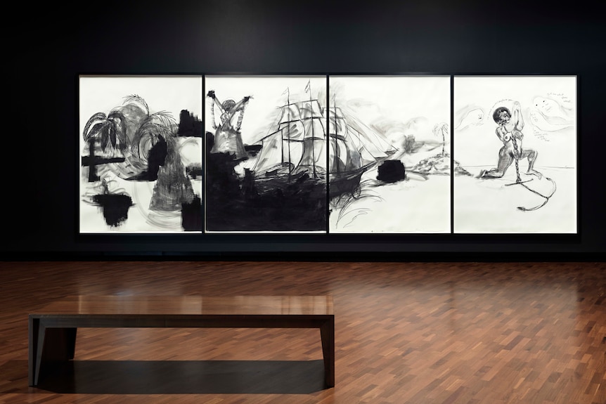 A large four panel sketch hanging in an empty gallery, depicting a slave ship and a female slave with an anchor around her neck