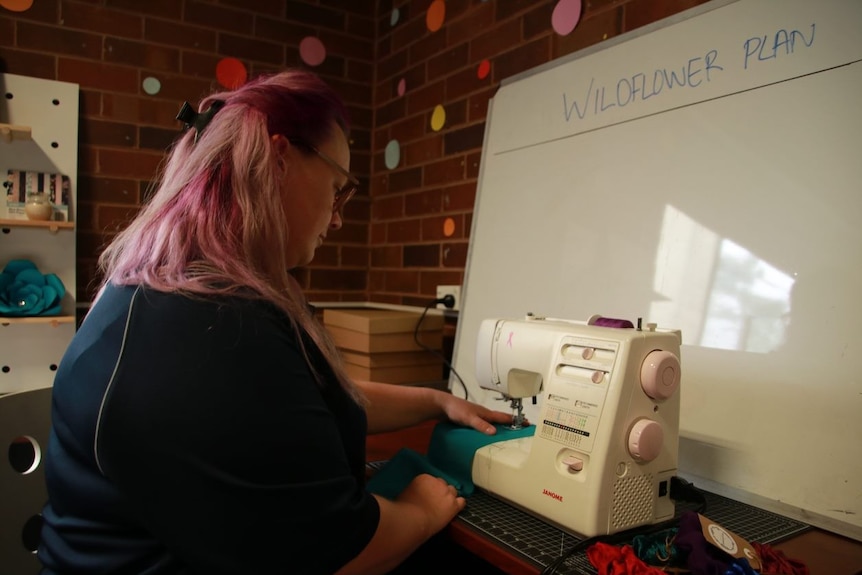 woman sitting in front of a sewing machine