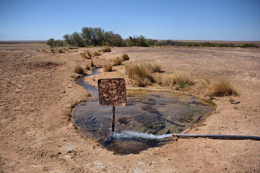 A rusted sign inside a bore in South Australia's desert