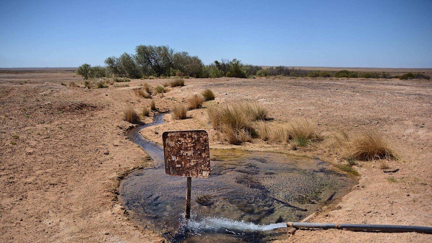 A rusted sign inside a bore in South Australia's desert