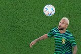 Brazil's Neymar kicks a ball over his head before a Qatar World Cup game against South Korea.