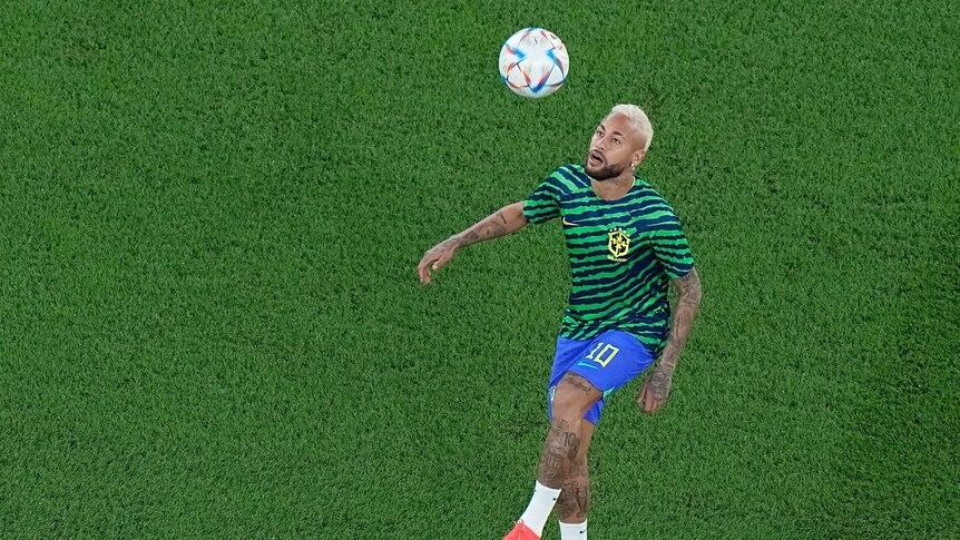 Brazil's Neymar kicks a ball over his head before a Qatar World Cup game against South Korea.