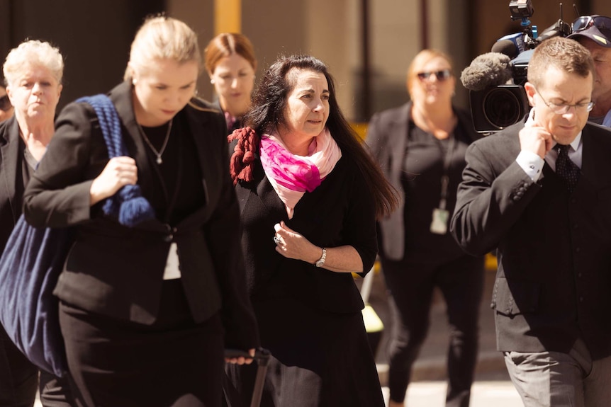 A group of lawyers dressed in black outside court.