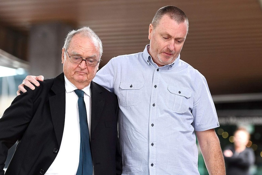 Jon Knowles (centre) and Mark Knowles (right), father and brother of murder victim Patricia Riggs, outside court in 2018.