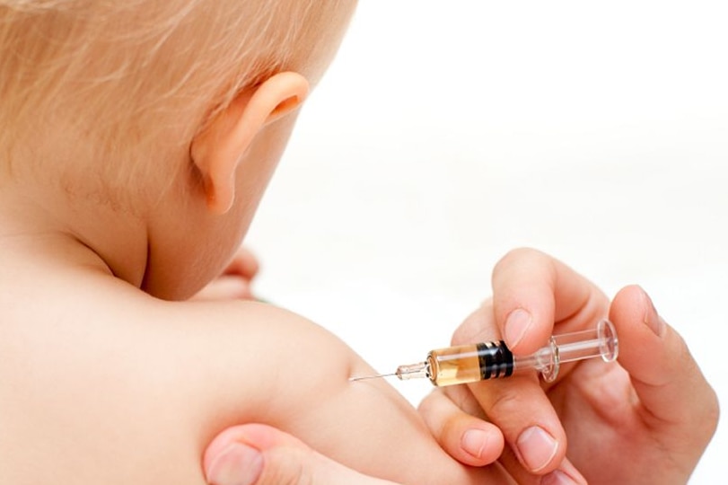 A baby being give a vaccine.