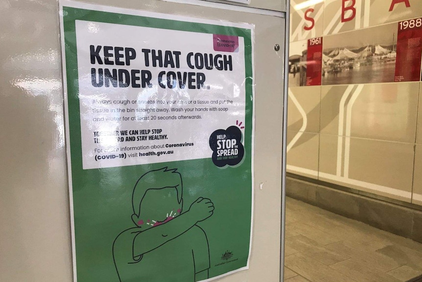 sign reads 'keep that cough under cover'