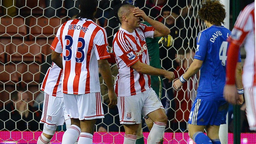 Stoke City forward Jon Walters (C) reacts after missing a penalty against Chelsea.