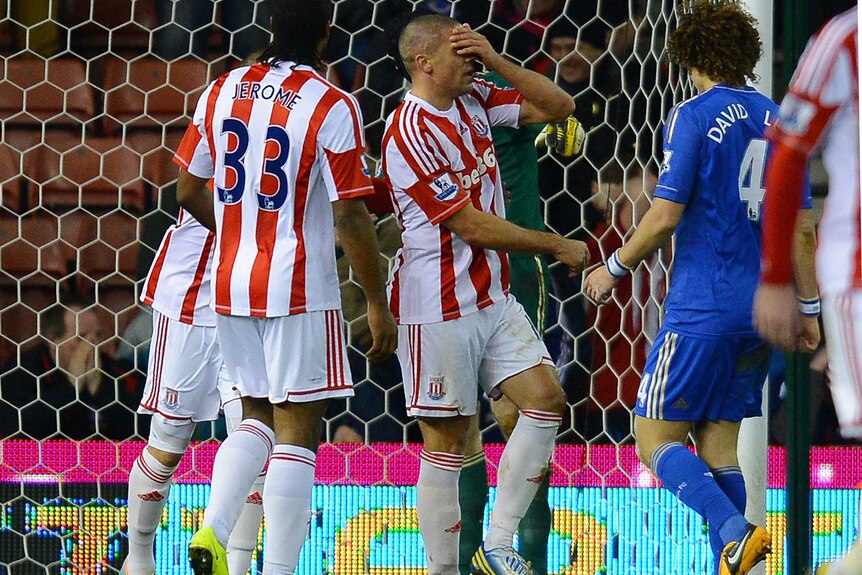 Stoke City forward Jon Walters (C) reacts after missing a penalty against Chelsea.