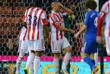 Stoke City forward Jon Walters (C) reacts after missing a penalty against Chelsea.