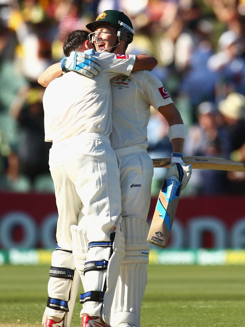 Michael Clarke (right) and Mike Hussey embrace after reaching a double-century and century respectively off consecutive deliveries.