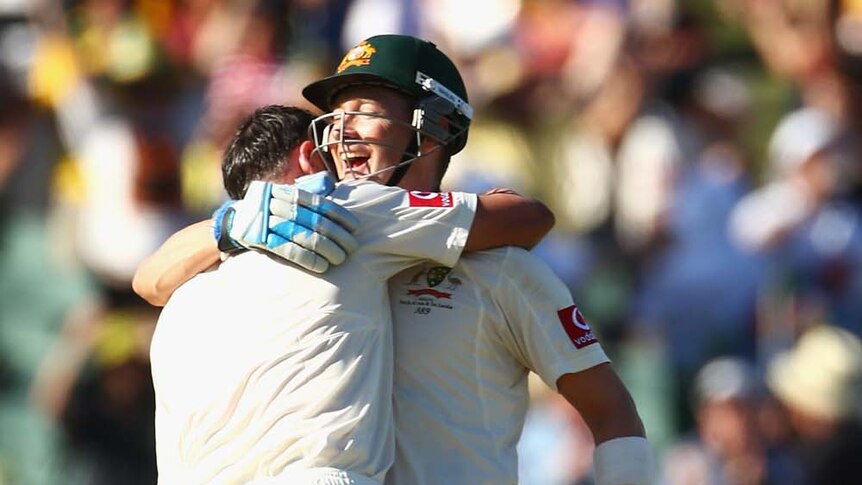 Michael Clarke (right) and Mike Hussey embrace after they reached a double-century and century respectively