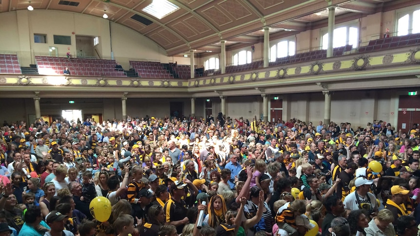 Hawthorn supporters cram into Hobart City Hall to celebrate Grand Final victory