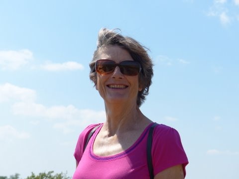 Jenny Hann standing outside against a blue sky.