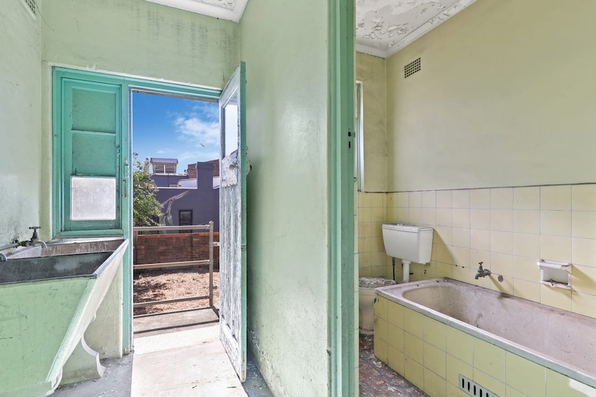 A bathroom in poor condition in a house