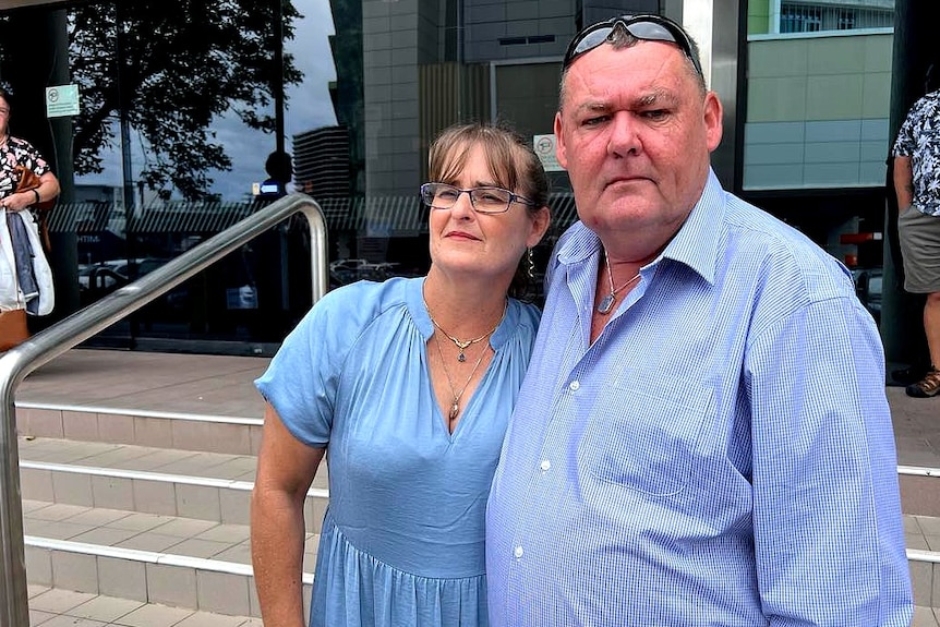 Woman and man standing outside court