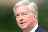 Michael Fallon arrives at 10 Downing Street in central London.