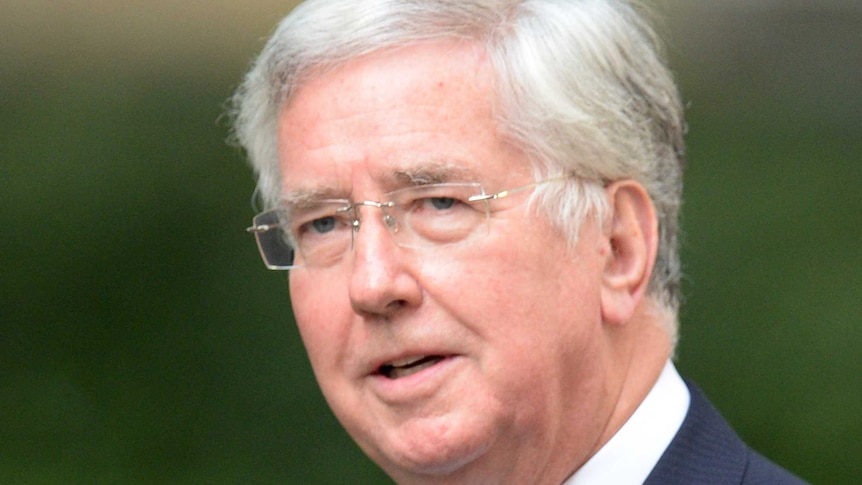 Michael Fallon arrives at 10 Downing Street in central London.