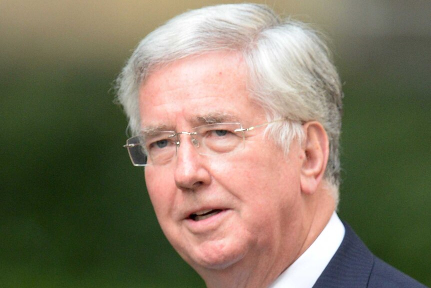 Michael Fallon arrives at 10 Downing Street in central London.