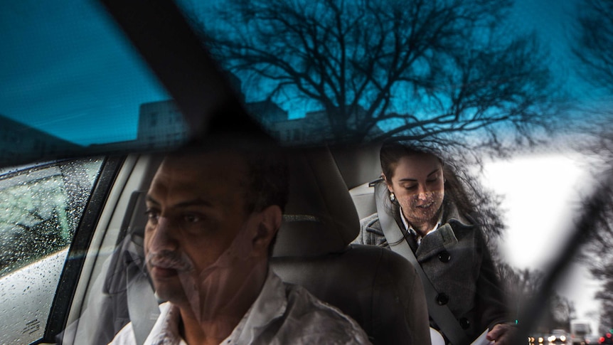 An UberX driver and his passenger are seen in the mirror of a car travelling in Virginia.