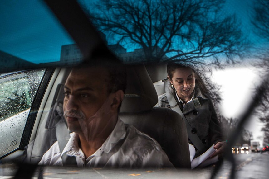 An UberX driver and his passenger are seen in the mirror of a car travelling in Virginia.