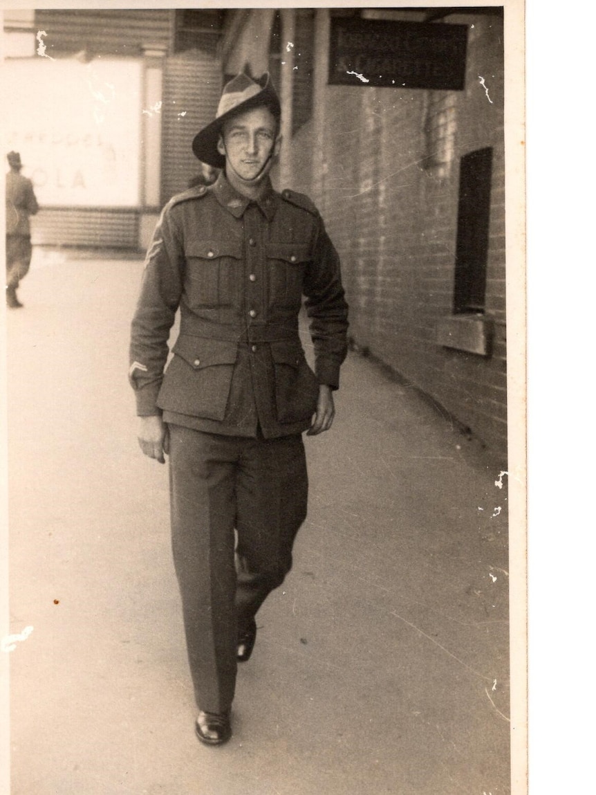 A black and white photo of Fred Power, smiling to the camera while wearing a military uniform and slouch hat.