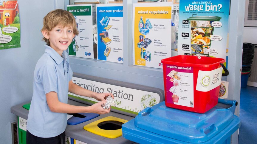 Student Toni Kuss putting foil in recycling bin