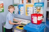 Student Toni Kuss putting foil in recycling bin