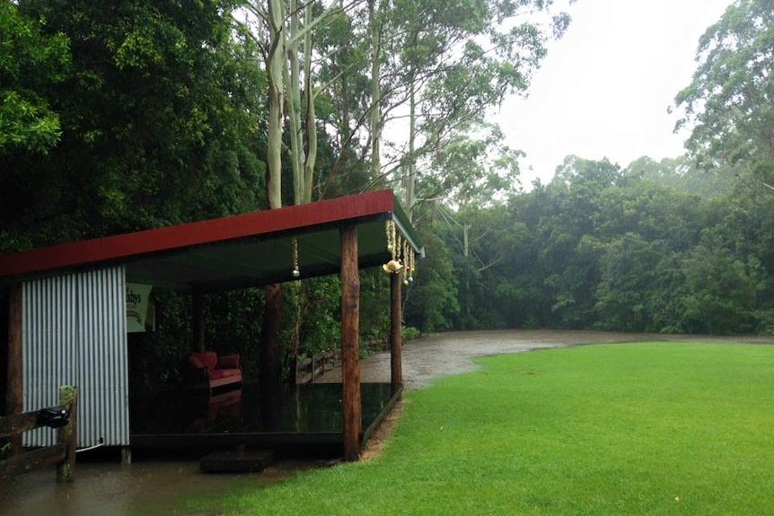 A creek floods over a green lawn at Great Lakes Winery.