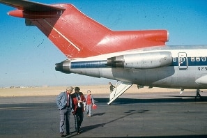A Boeing 727 on a tarmac with the rear stairs deployed