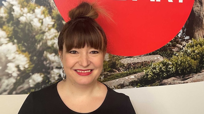 Bio-Artist Svenja Kratz stands in front of an ABC Hobart sign