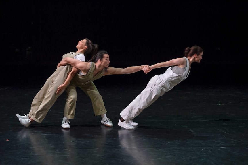 Dancers perform a contemporary construction themed routine on stage