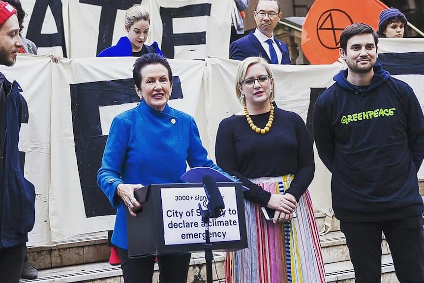 Clover Moore speaks alongside protestors.