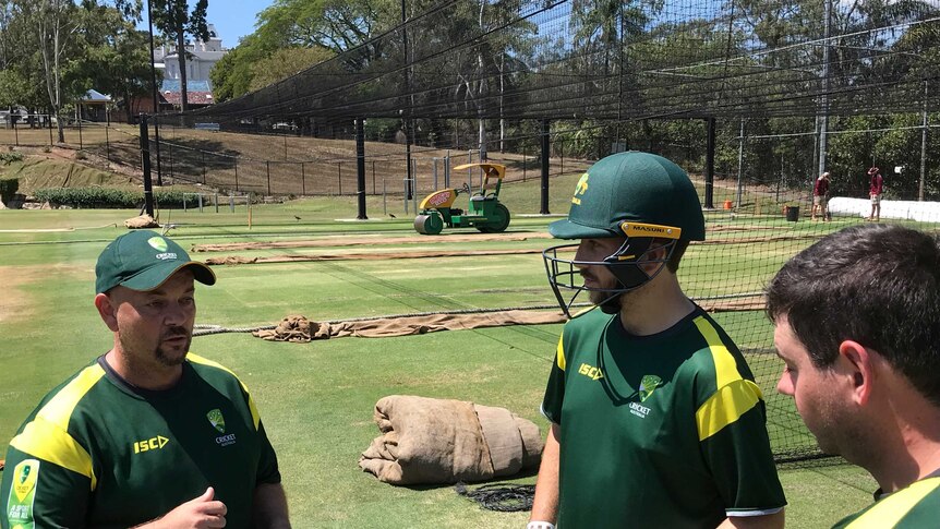 Cricket coach John Lonergan in the nets with players.