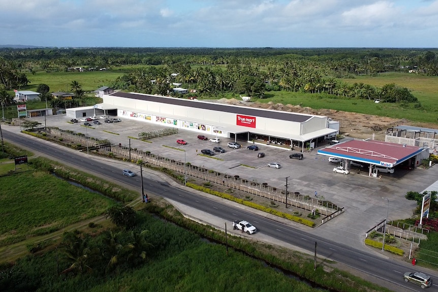 An aeriel drone picture of a Tru Mart and Mobil petrol station. 