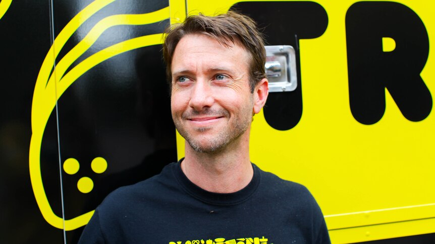 Travis Harvey, the executive chef at food rescue charity OzHarvest, stands in front of their new truck